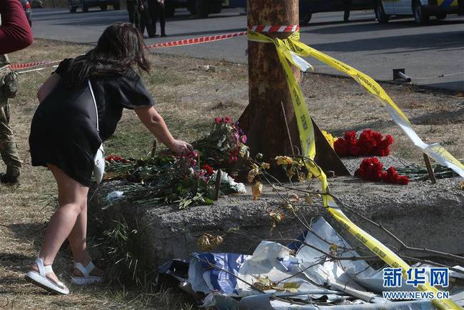 9月26日，当地居民在乌克兰哈尔科夫州的飞机坠毁现场外献花致哀。 谢尔盖·斯塔拉斯坚科摄